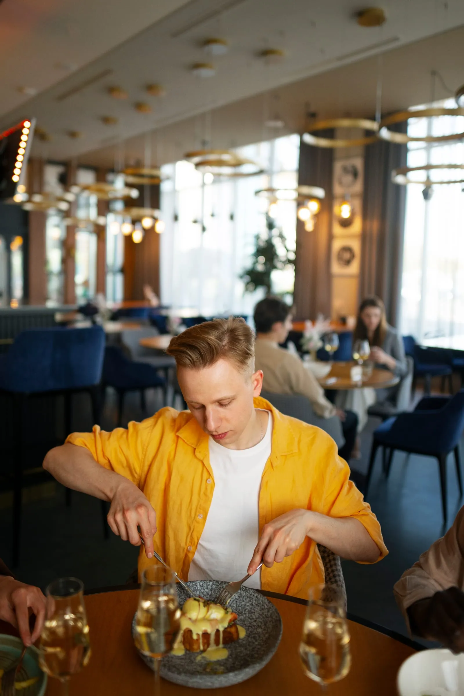 A full restaurant room at lunch, guests at their tables