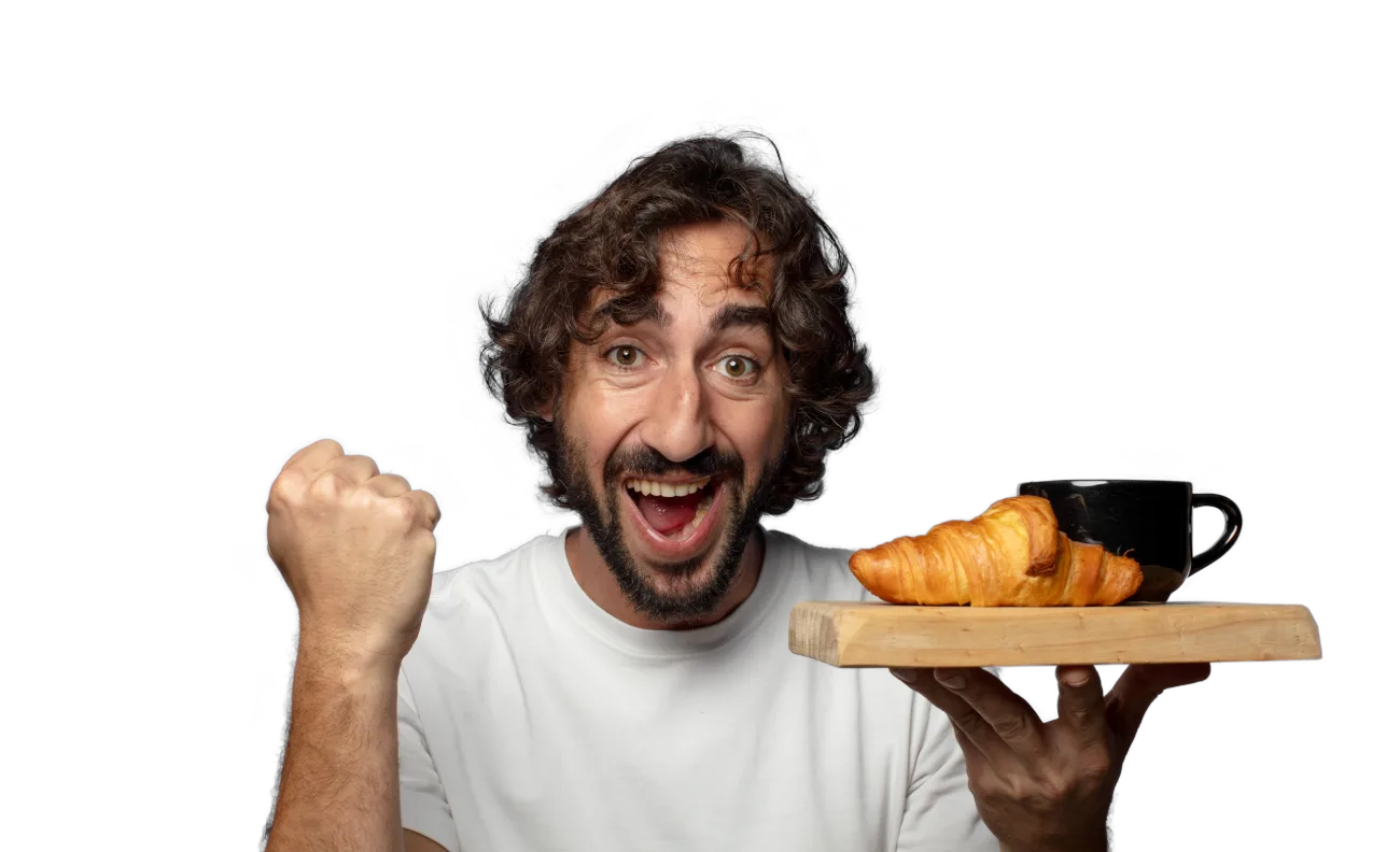 Team member with coffee and a croissant